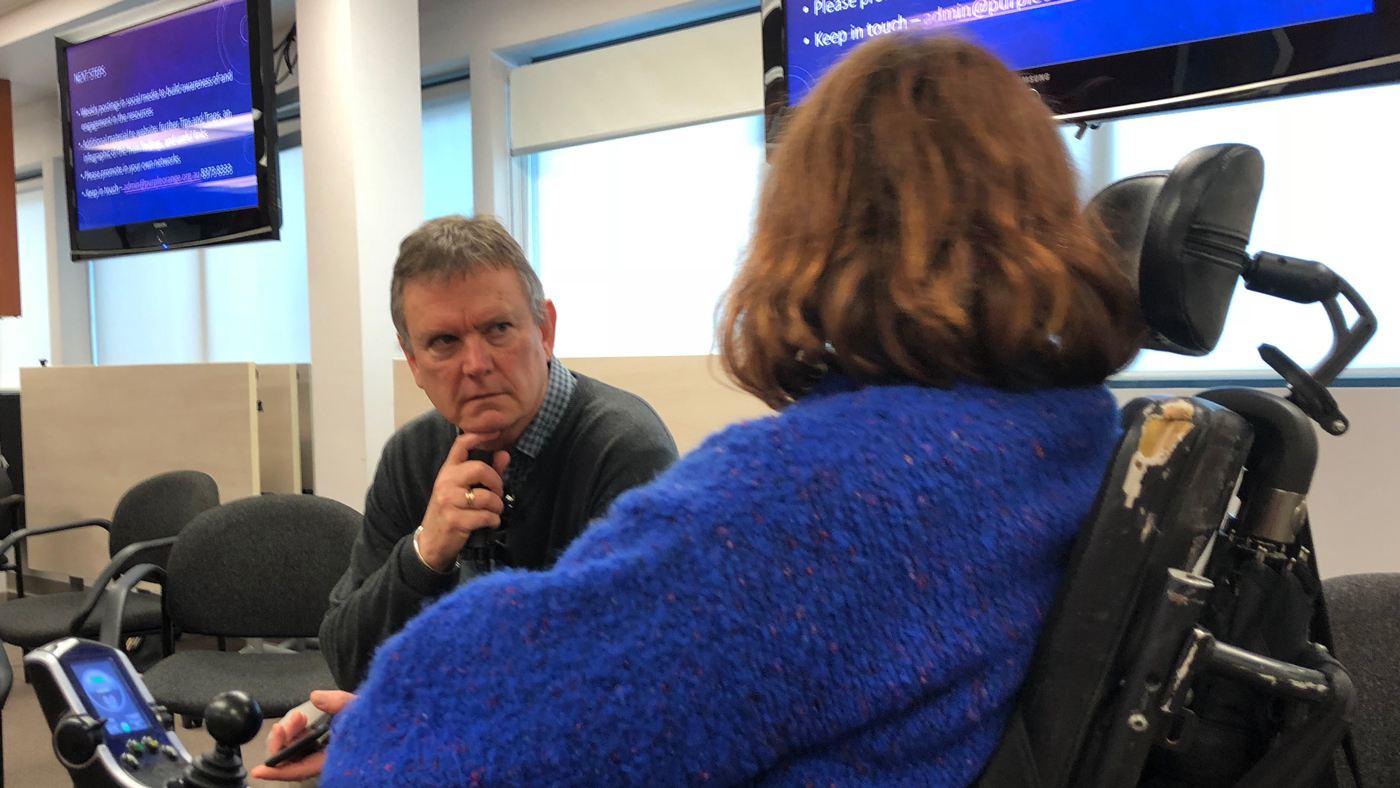 two people at office table Board member and Staff member in conversation