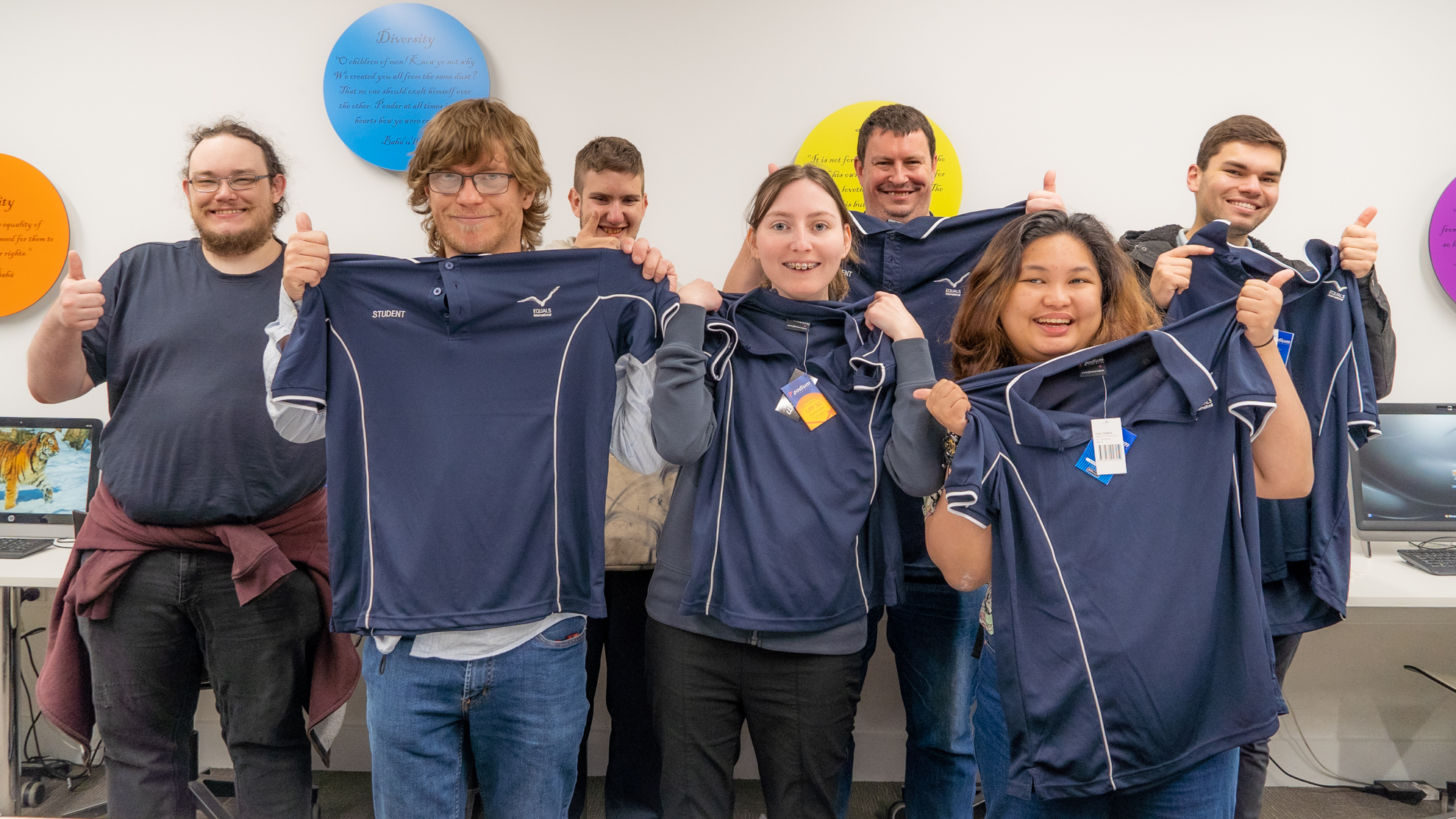 Photo of the first traineeship group holding up their traineeship t-shirt