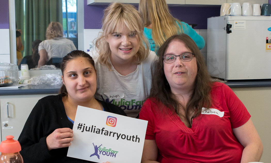 Three members holding a sign that says #JuliaFarrYouth