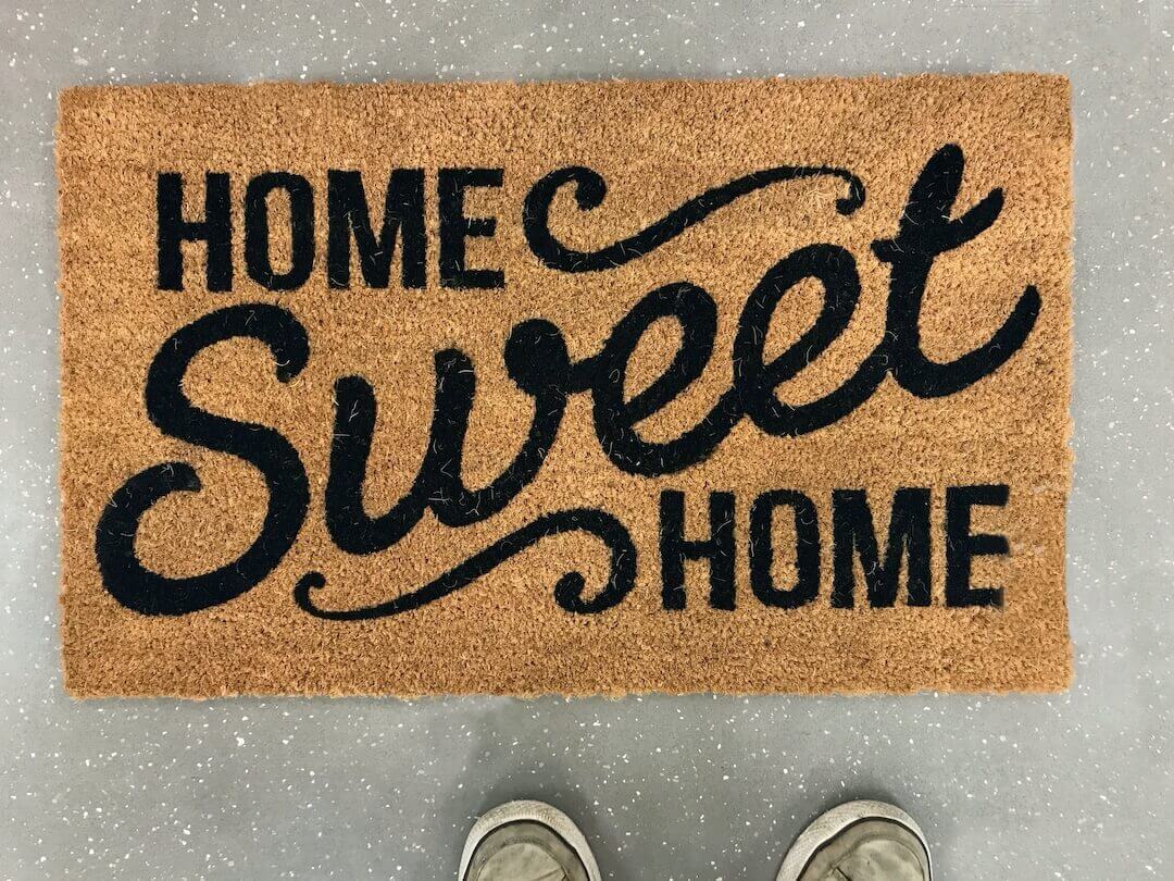 Photo of a brown thatched doormat with words Home Sweet Home. Photo of a brown thatched doormat with words Home Sweet Home.
