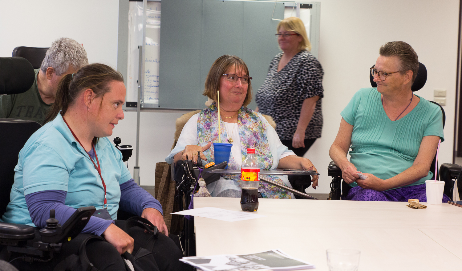 Disability Elders of All Ages Meeting showing several members using straws to drink