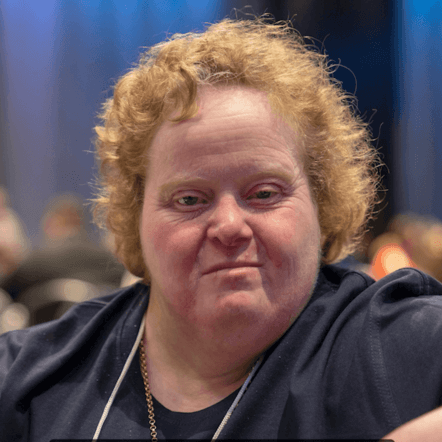 Photo of Rachel.She has white skin, curly light brown hair and is wearing a dark blue top.