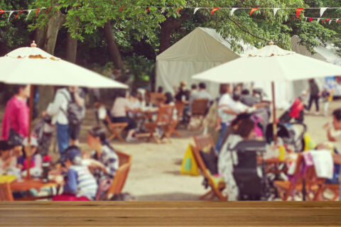 Photo of a busy outdoor events with details blurred out. Blurred photo of a busy outdoor event.