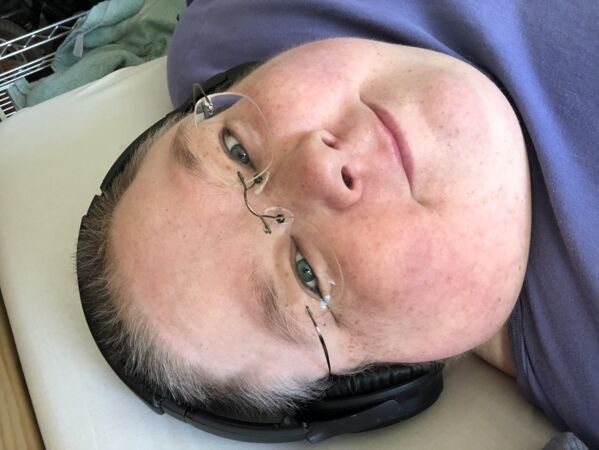 COVID-19 has made things more accessible to Ricky because she can now watch major events like concerts online at home. Here Ricky is smiling at the camera with headphones on.