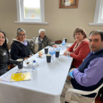 Group of community members smiling at camera.