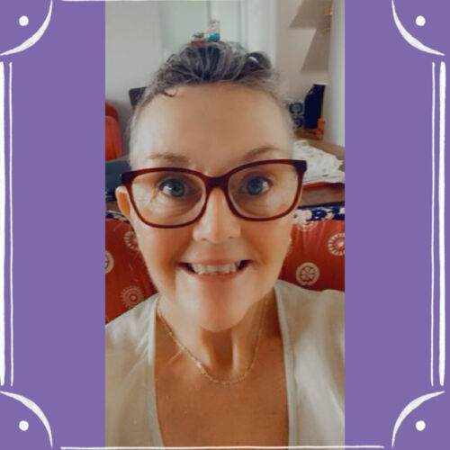Graphic of a purple background with a frame of straight white lines and curved corners, in the middle is a selfie photo of Annett beaming at the camera. She is a white woman with short dark grey hair swept back over forehead, red glasses framing her eyes. A purple background with a frame of straight white lines and curved corners, in the middle is a selfie photo of Annett beaming at the camera. She is a white woman with short dark grey hair swept back over her forehead, red glasses framing her eyes.