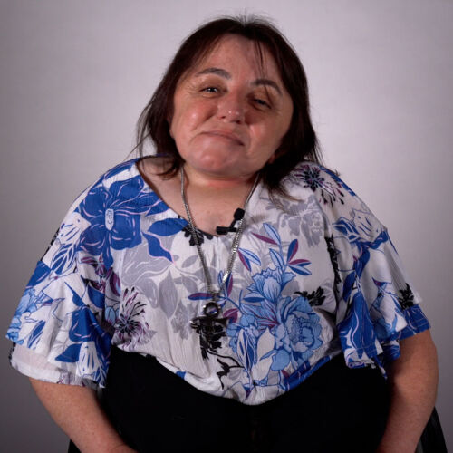 Photo of Abby, one of the disability inclusion advisory members, smiling at camera