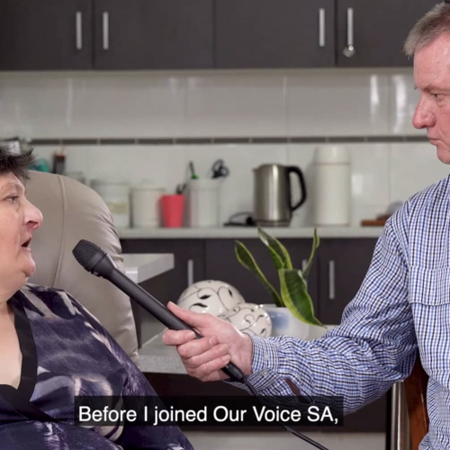 Gavin is holding out a microphone to Libby.
